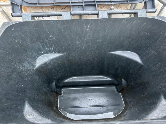 The same trash barrel after cleaning, rinsed out and spotless