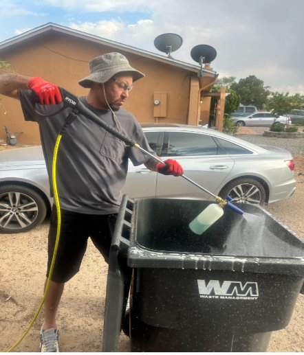 Applying foaming cleaner inside a trash barrel